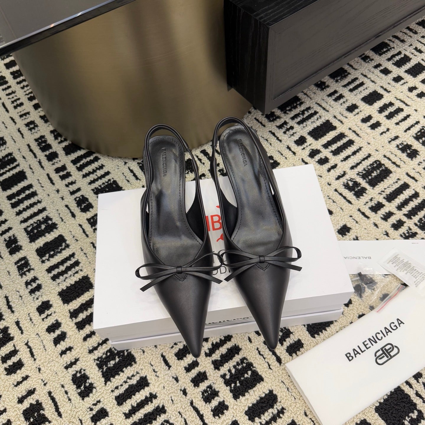 Black pointed-toe lace-up heels with stiletto heel