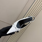 White pointed-toe slingback heel with black lining
