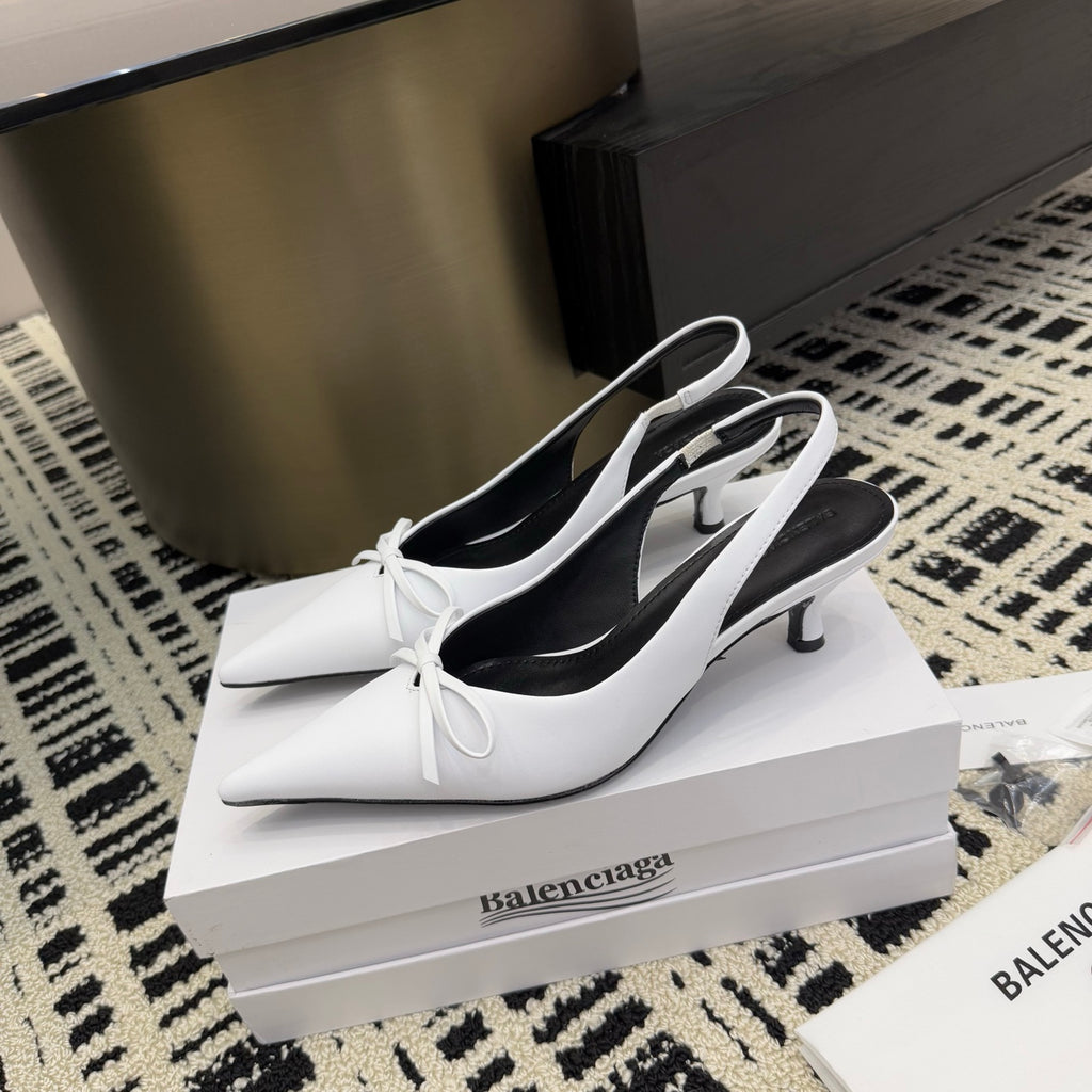 White slingback heels with bow ties and black lining
