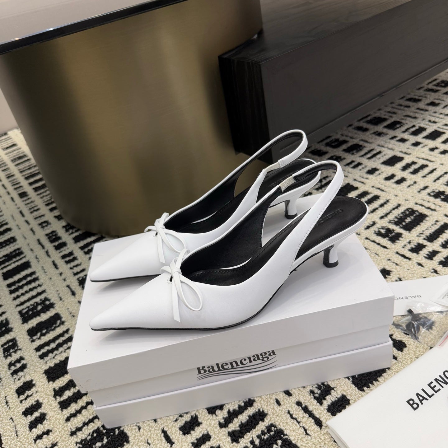White slingback heels with bow ties and black lining