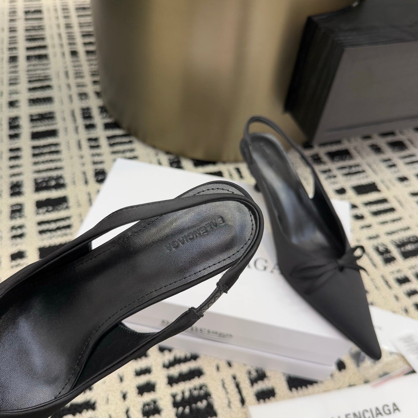 Women's black pointed toe slingback shoe with bow, side view