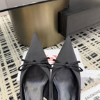 Women's black pointed toe slingback shoes with bow, front view