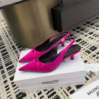 Women's hot pink pointed-toe pumps with bow slingback straps and stiletto heels