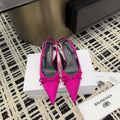 Women's hot pink pointed-toe pumps with bow detail and stiletto heels