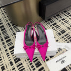 Women's hot pink pointed-toe pumps with bow detail and stiletto heels