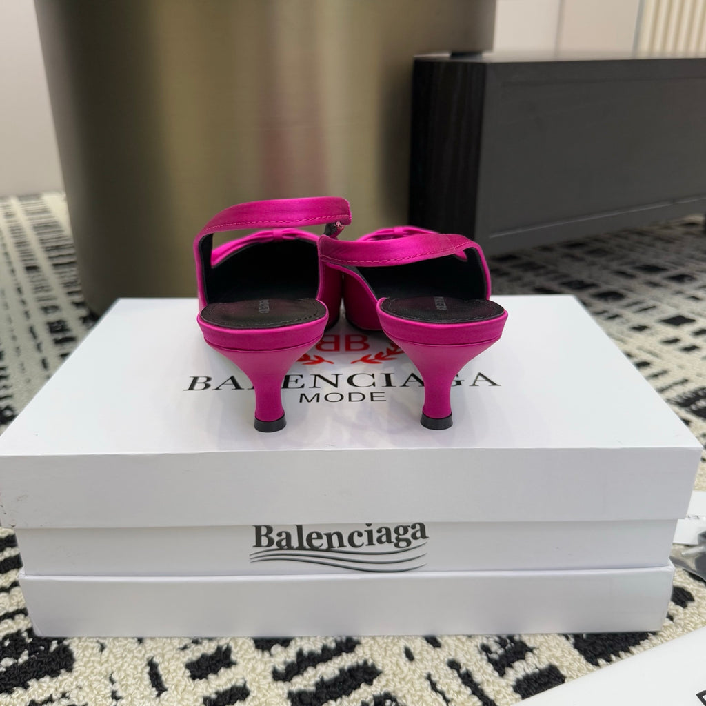Women's hot pink slingback pumps with stiletto heels and bow straps
