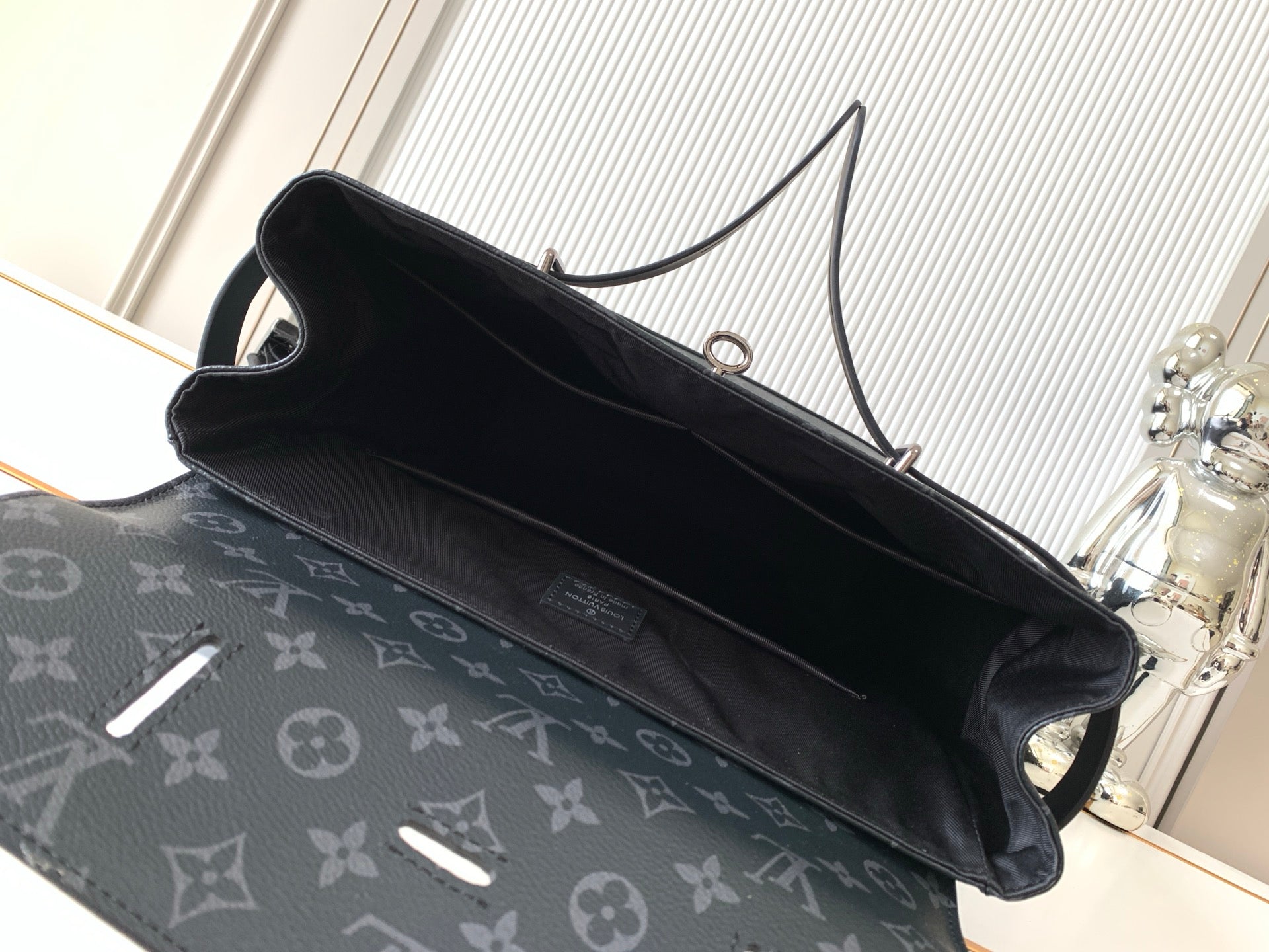 Louis Vuitton bag interior with black lining and open top zipper
