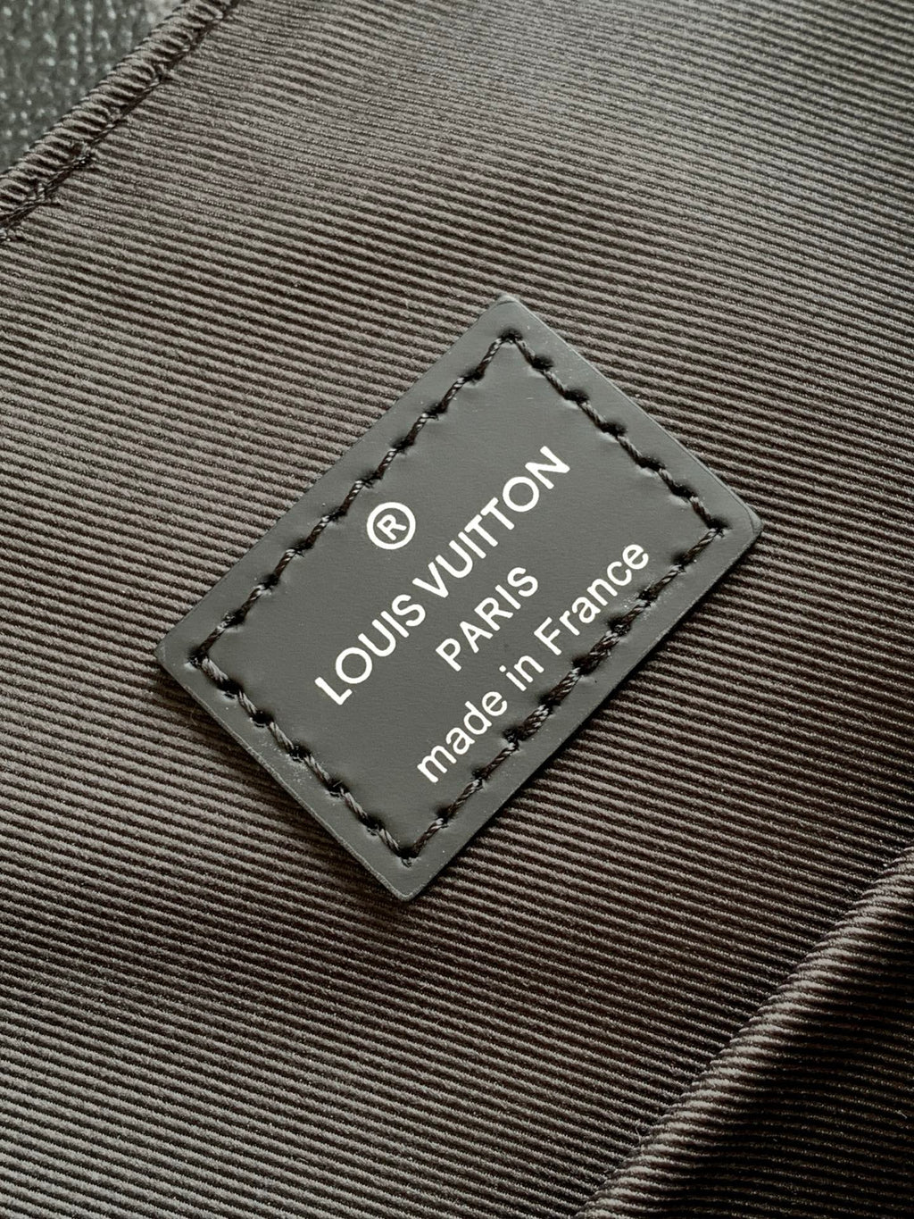 Louis Vuitton tag on monogram bag fabric reading "made in France"