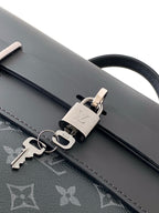 Louis Vuitton bag detail: black leather strap with metal clip and stitched monogram tab