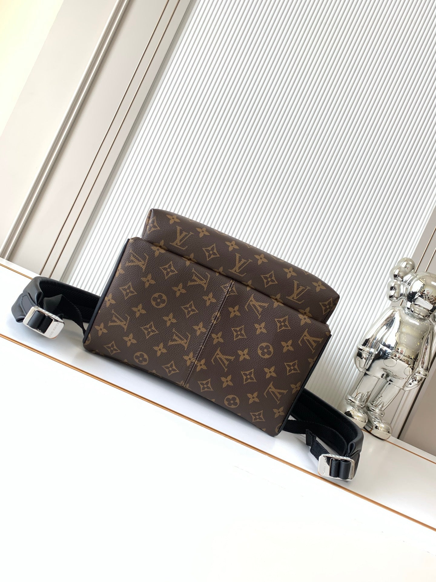 Louis Vuitton monogram backpack front view with buckle strap details and black trim