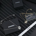 Chanel silver-tone pendant necklaces with pearl flower charms, chain and clasp