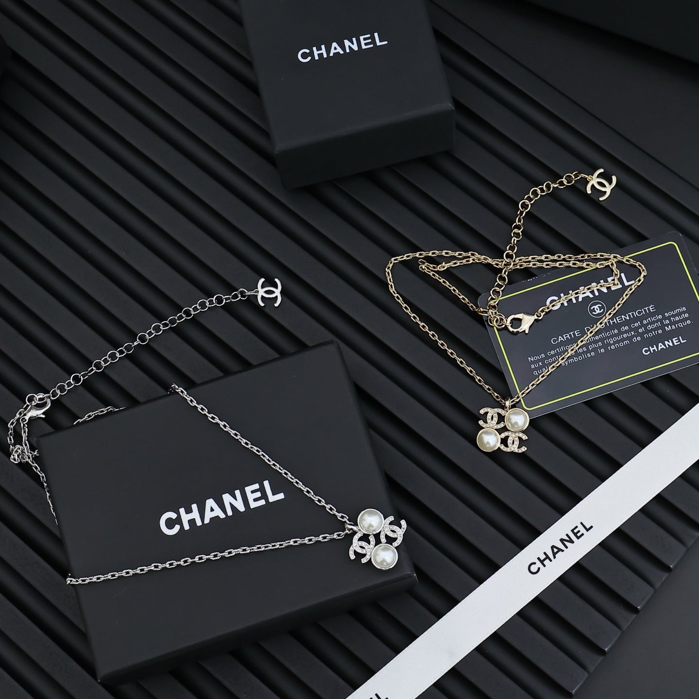 Chanel silver-tone pendant necklaces with pearl flower charms, chain and clasp