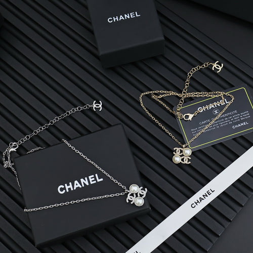 Chanel silver-tone pendant necklaces with pearl flower charms, chain and clasp