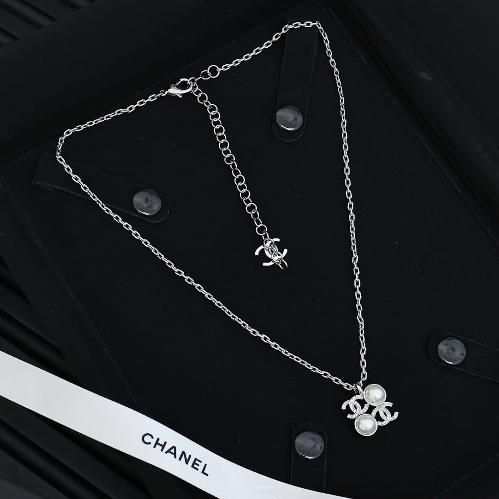 Chanel silver-tone long chain necklace with pearl flower charm and logo detail