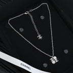 Chanel silver-tone long chain necklace with pearl flower charm and logo detail