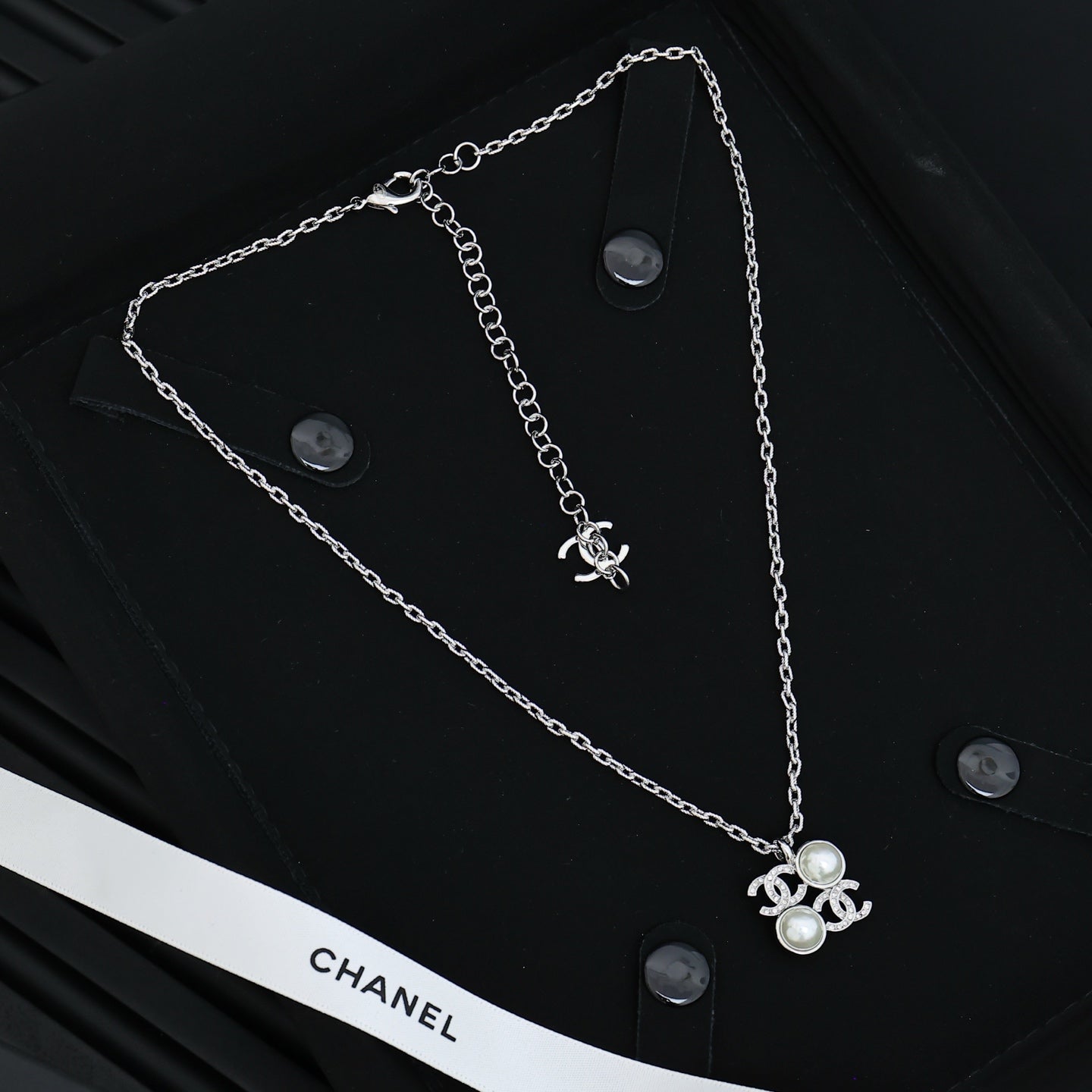 Chanel silver-tone long chain necklace with pearl flower charm and logo detail