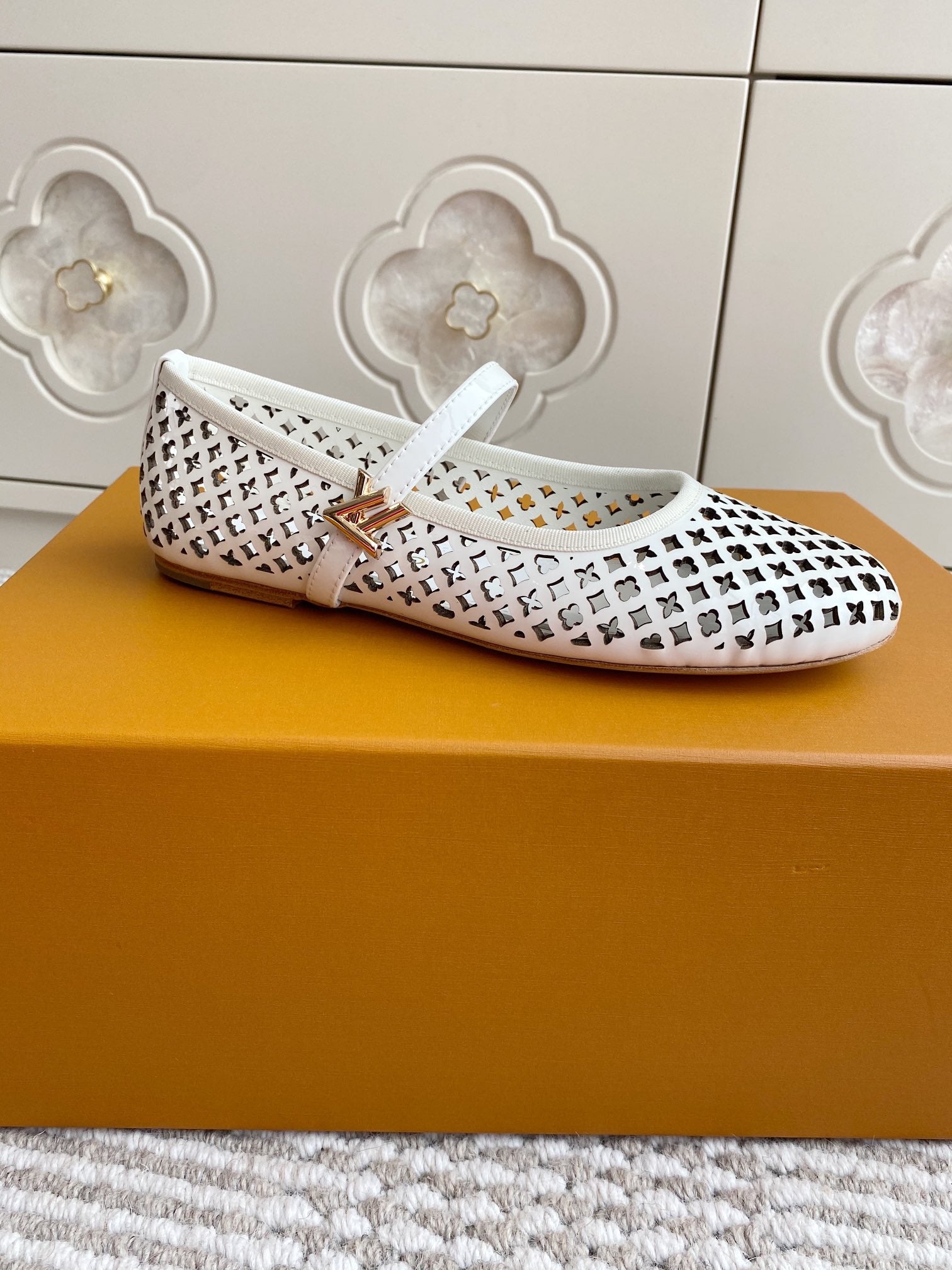 Louis Vuitton logo-pattern slip-on flats with white strap, angled side view