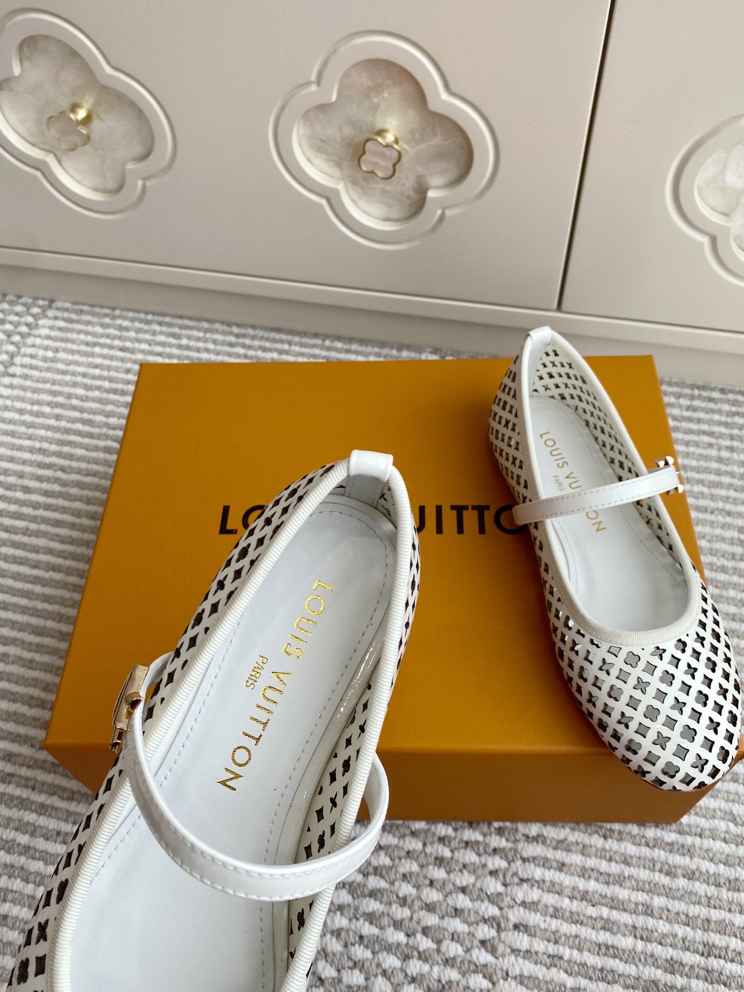 Louis Vuitton logo-pattern flats with white strap, interior lining visible, side view