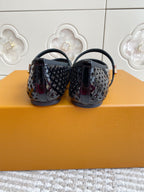Black patterned flat ballerina shoes with curved handles, back view