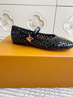 Black and white patterned flat ballerina shoe with buckle strap, side profile