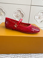 Women's Louis Vuitton red flats with cutout lattice design and gold buckle strap