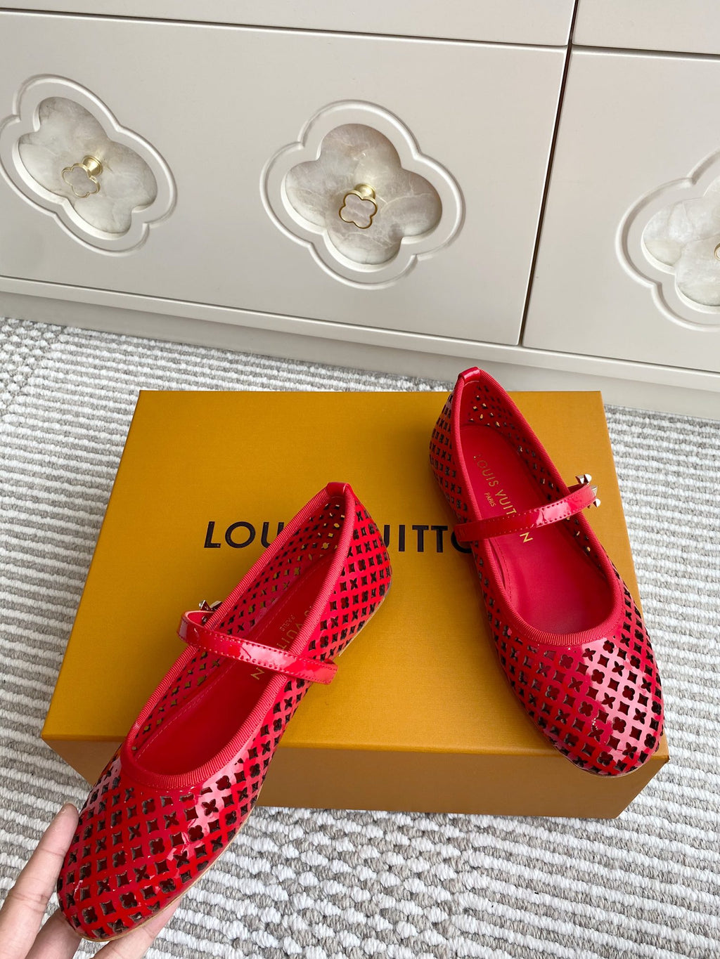 Women's Louis Vuitton red flats with lattice pattern and V-shaped strap