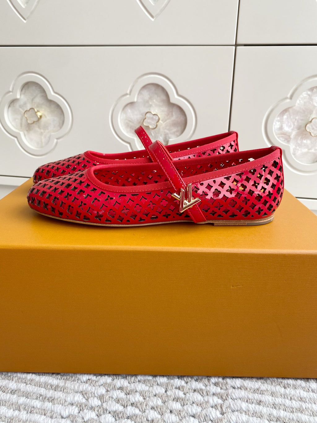 Women's Louis Vuitton red flats with cutout lattice upper and ankle strap