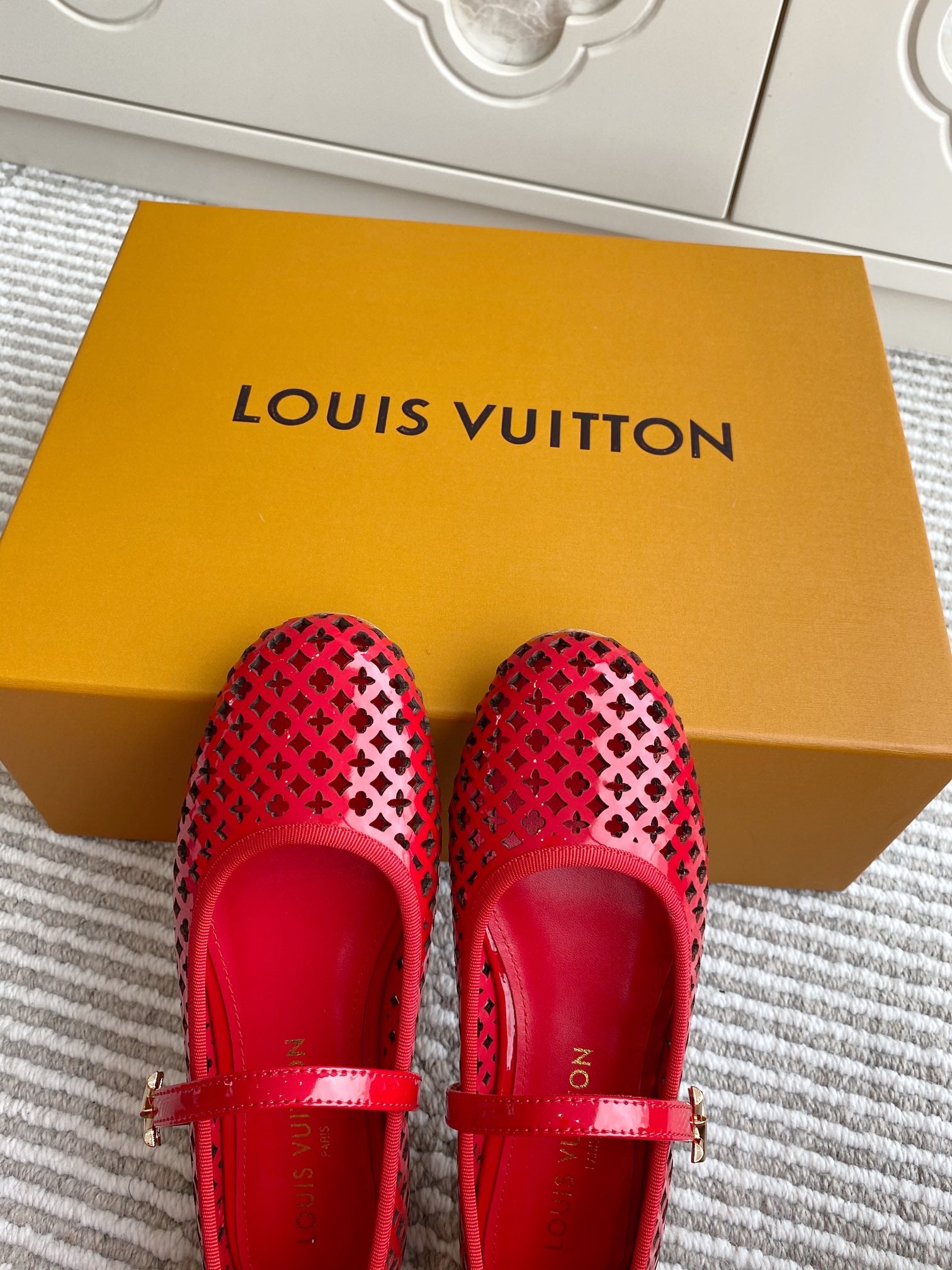 Women's Louis Vuitton red flats with front strap and perforated lattice design