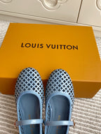 Front view of light blue perforated ballet flats with ankle strap