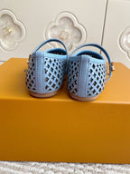 Back view of light blue perforated flats with ankle strap and open heel
