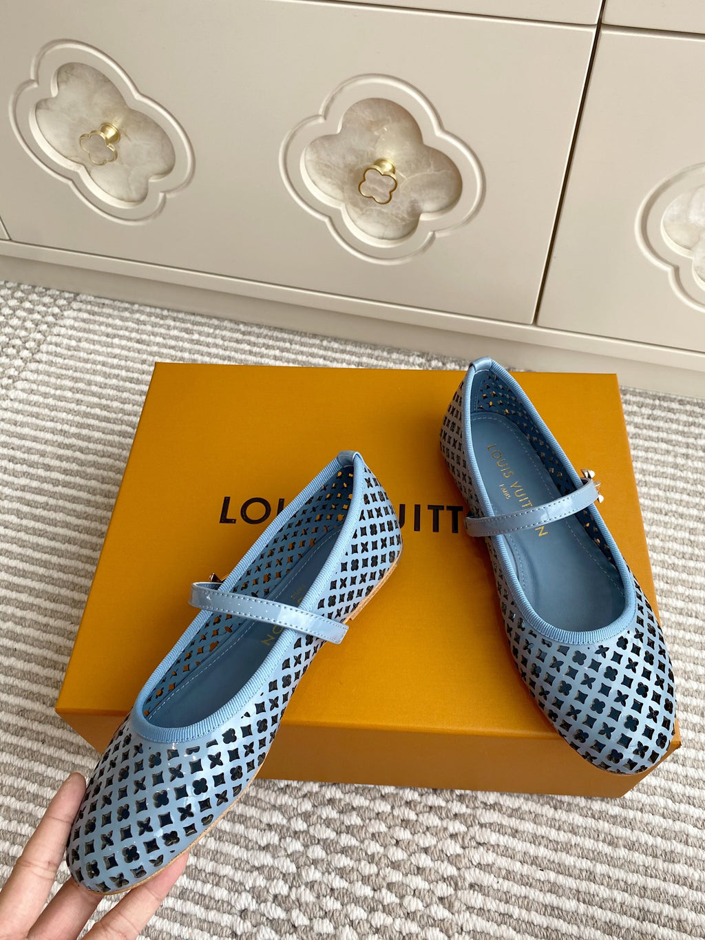 Blue lattice ballet flats with light blue ankle strap on a retail box