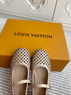 Women’s Louis Vuitton monogram flats front view, cream patterned canvas with light leather strap.