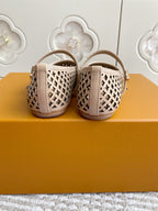 Women’s Louis Vuitton monogram flats rear view, cream patterned canvas, low heel, strap and buckle.
