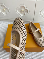 Women’s Louis Vuitton monogram flats side view, cream perforated pattern and adjustable strap with buckle.