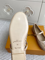 Women’s Louis Vuitton monogram flats sole and heel view, cream leather outsole with branding text.