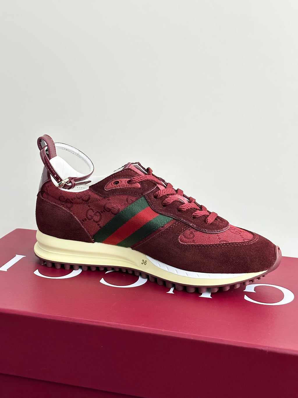 Ladies dark red suede sneakers with green stripe, lace-up design, cream sole