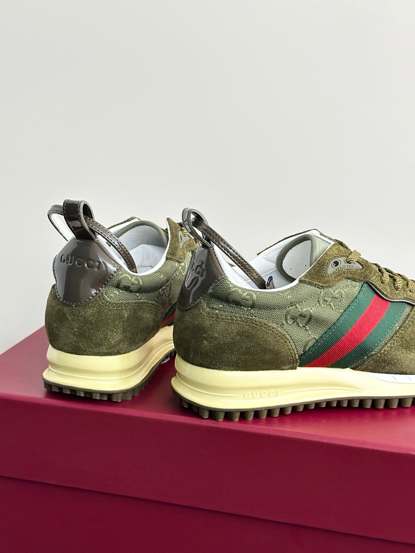 Olive Gucci ladies sneakers, rear view with heel pull tabs and Web stripe on side