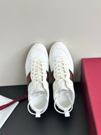 Gucci white lace-up sneakers, front view with green-red stripe and yellow sole