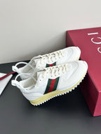 Gucci white lace-up sneakers with green-red stripe detail and yellow rubber sole