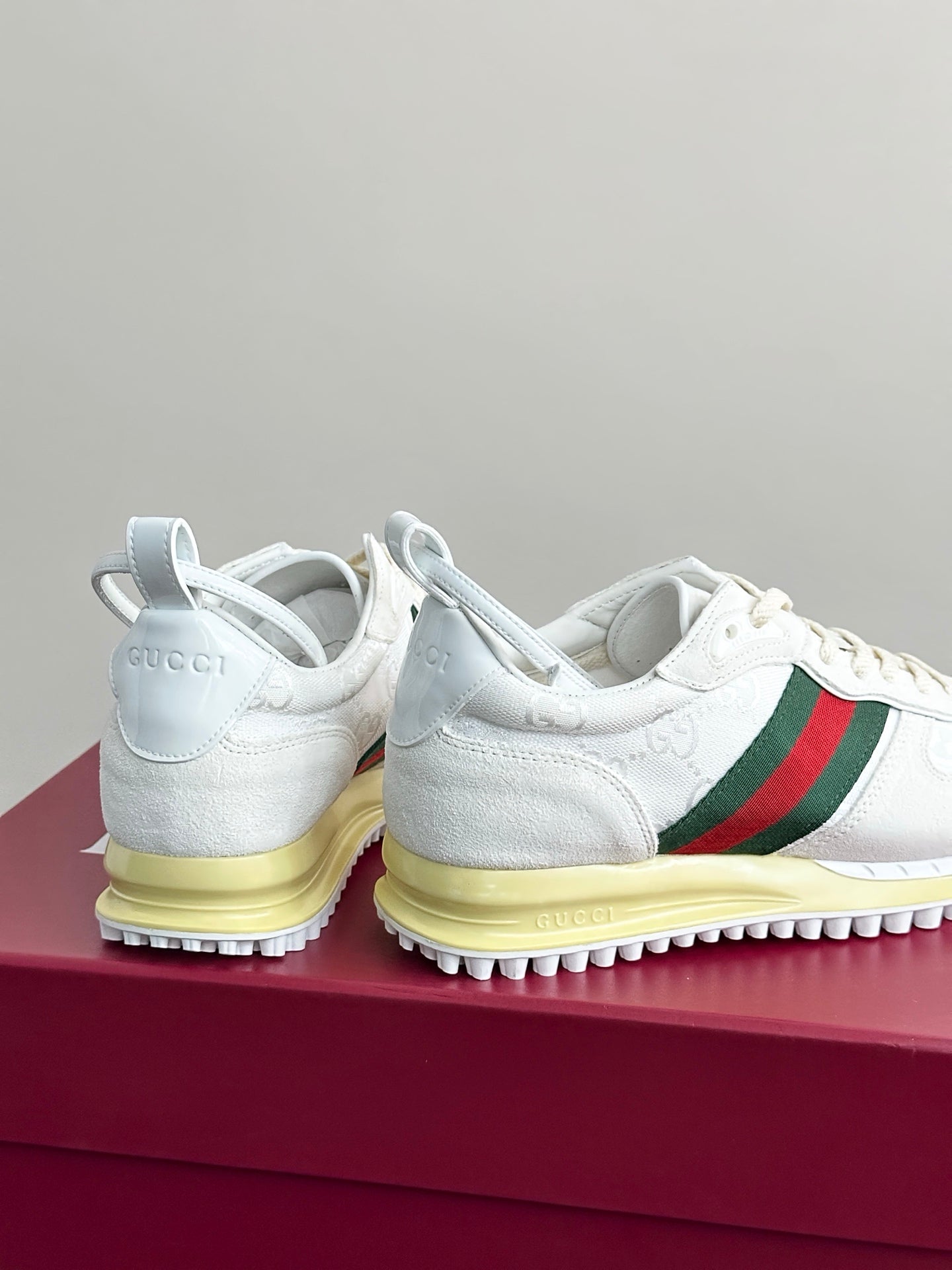 Gucci white sneakers back/heel view with green-red stripe and yellow sole