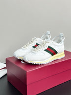 Gucci white lace-up sneakers on box, green-red stripe and yellow sole