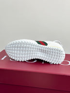 Gucci white sneaker outsoles with studded rubber tread and green-red stripe