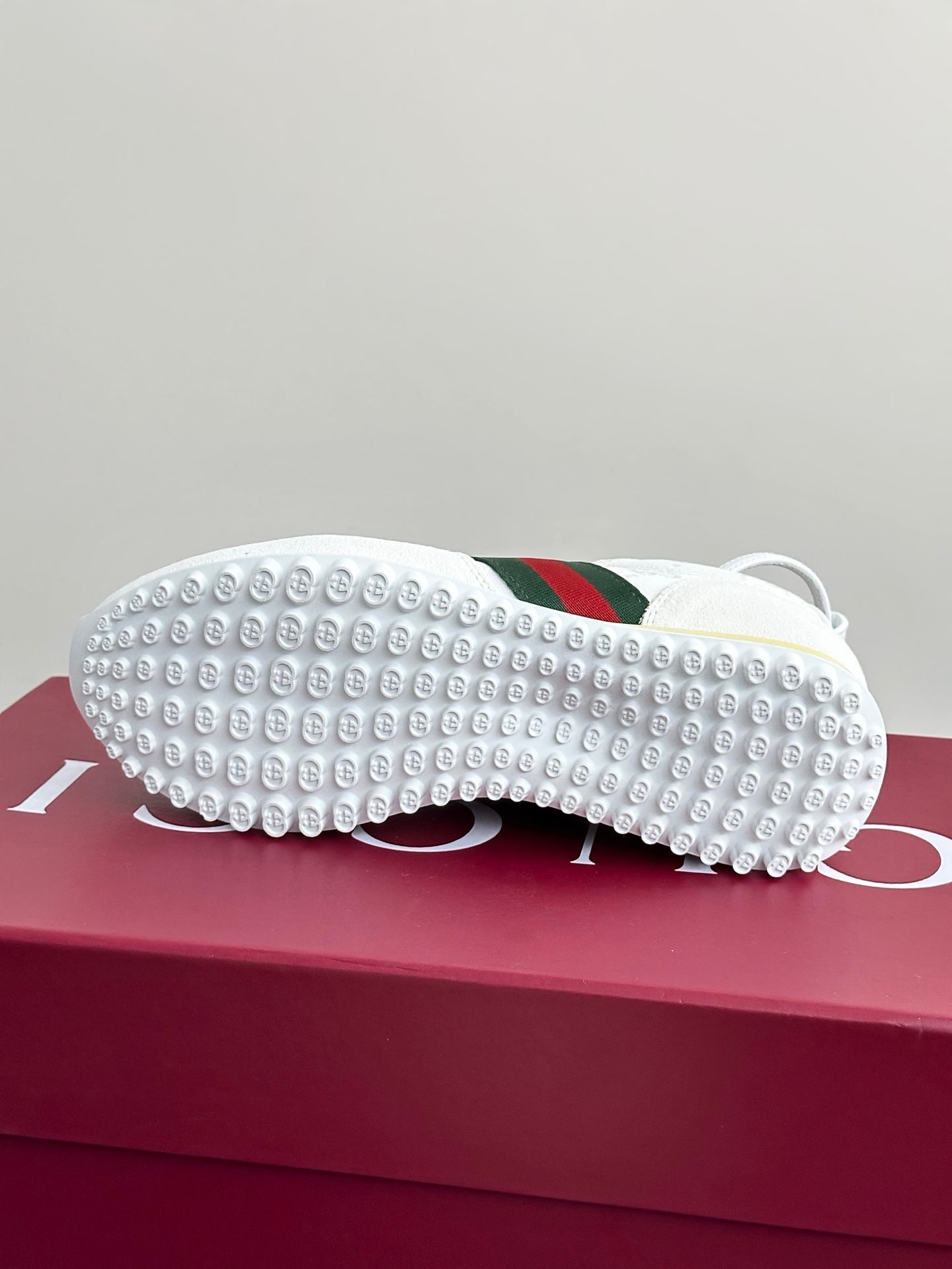 Gucci white sneaker outsoles with studded rubber tread and green-red stripe