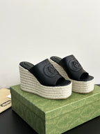 Gucci ladies black platform slide sandals with GG logo, showing both wedge sides