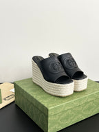Gucci ladies black platform slide sandals with GG embossed strap and espadrille wedge