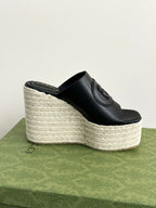 Gucci ladies black slide wedge sandal with espadrille-style wedge and GG embossed strap
