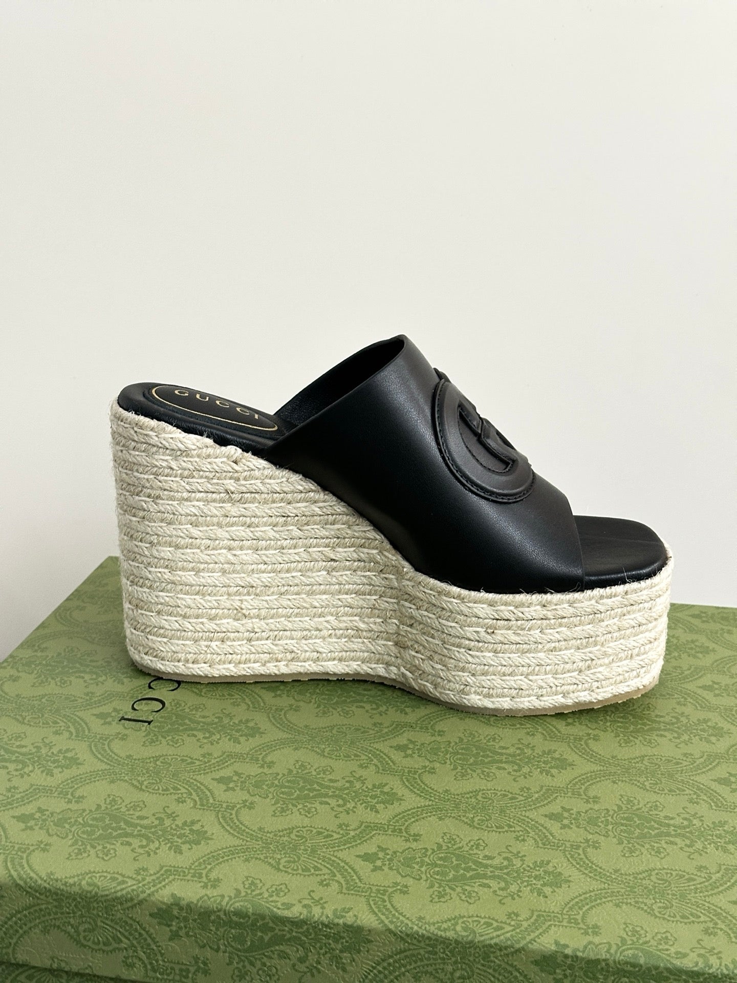 Gucci ladies black slide wedge sandal with espadrille-style wedge and GG embossed strap