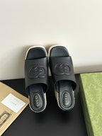 Gucci ladies black slide wedge sandals, showing two straps and GG logo on footbed
