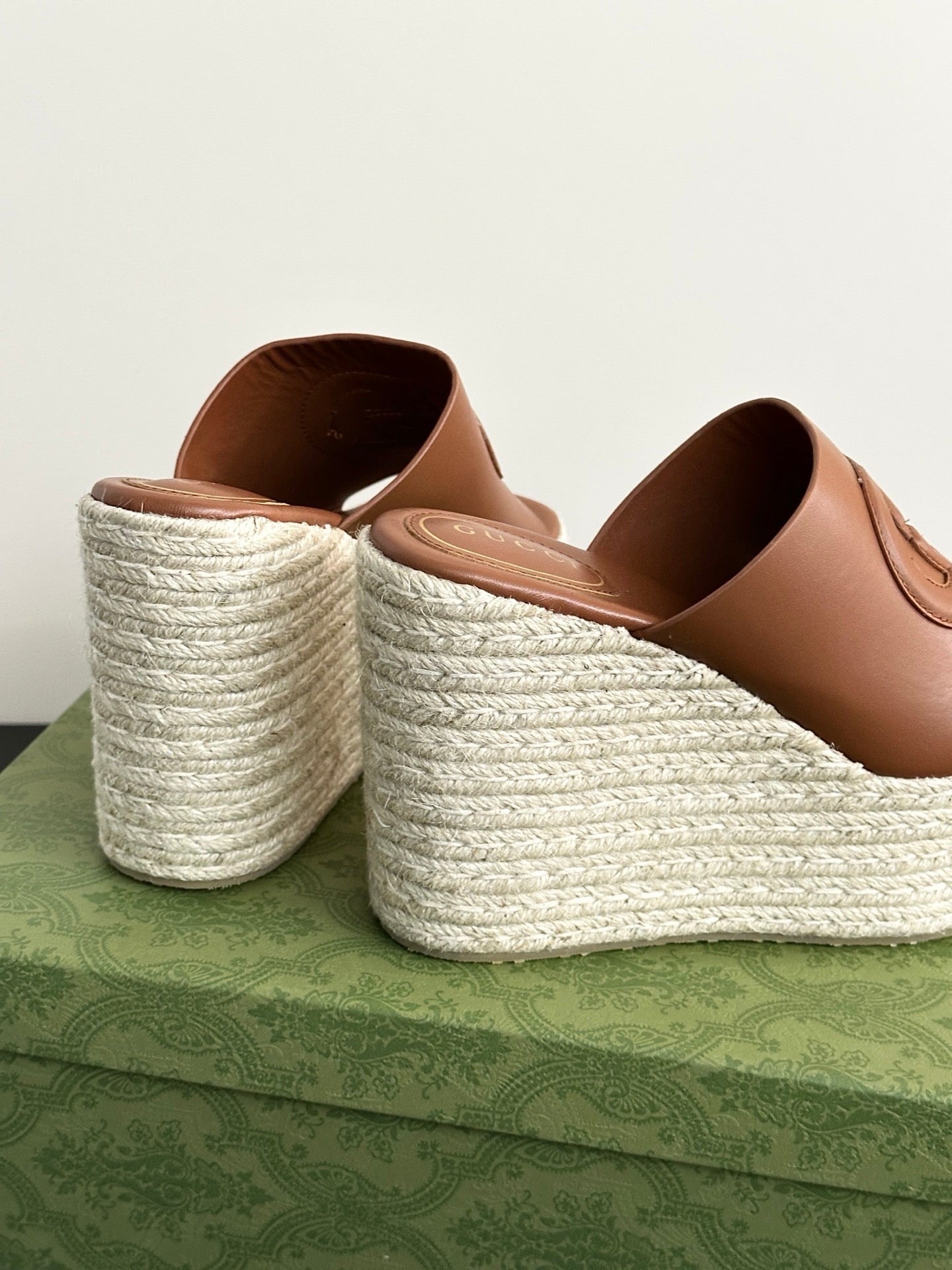 Gucci brown leather slide wedge sandals showing interior and espadrille textured platforms