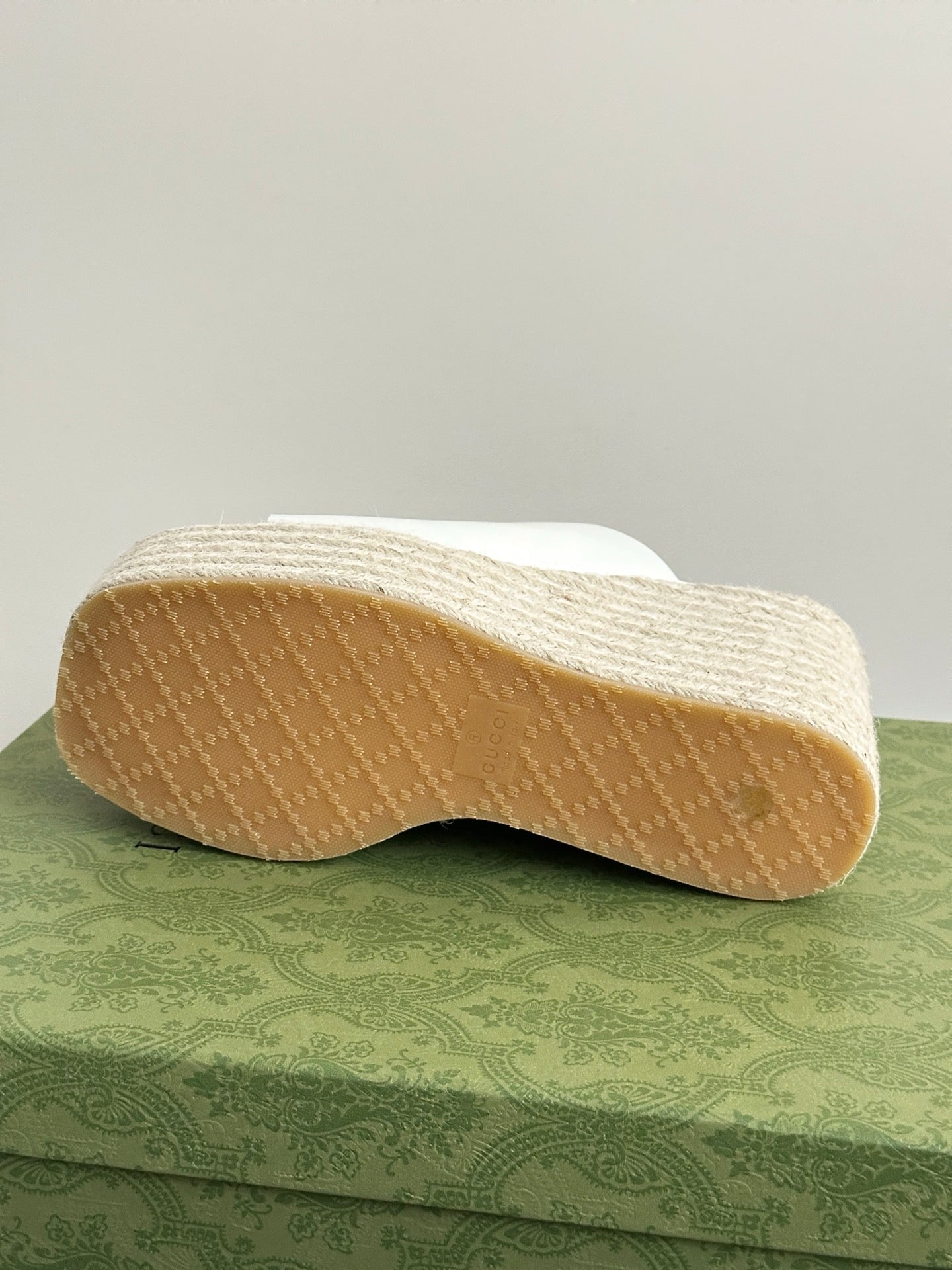 White Gucci platform slides outsole view, textured tread on espadrille wedge sole